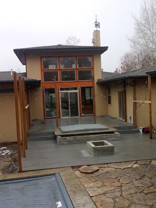 The Provo deck from the side, showing the multi-level transitions, the steps down to grade and the posts framing the covered area.