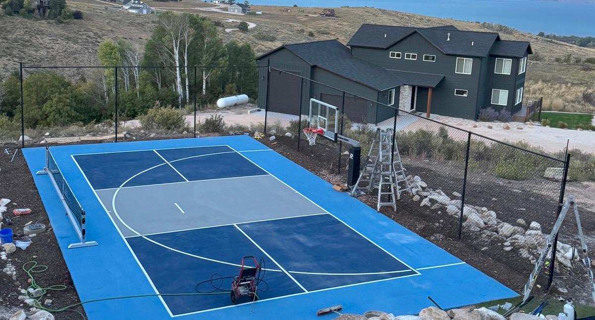 Aerial view of the Bear Lake multi-sport court with the lake behind it.