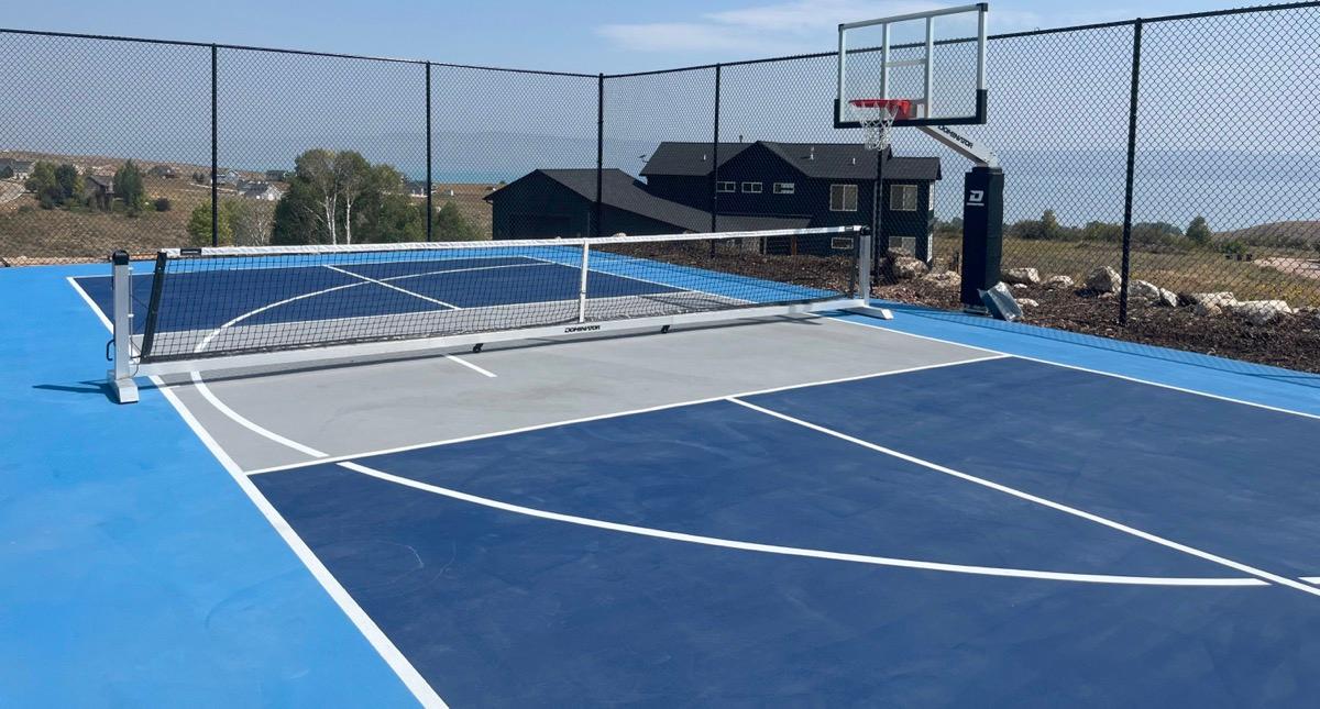 Close view of the Bear Lake court surface showing pickleball and basketball lines and the hoop.