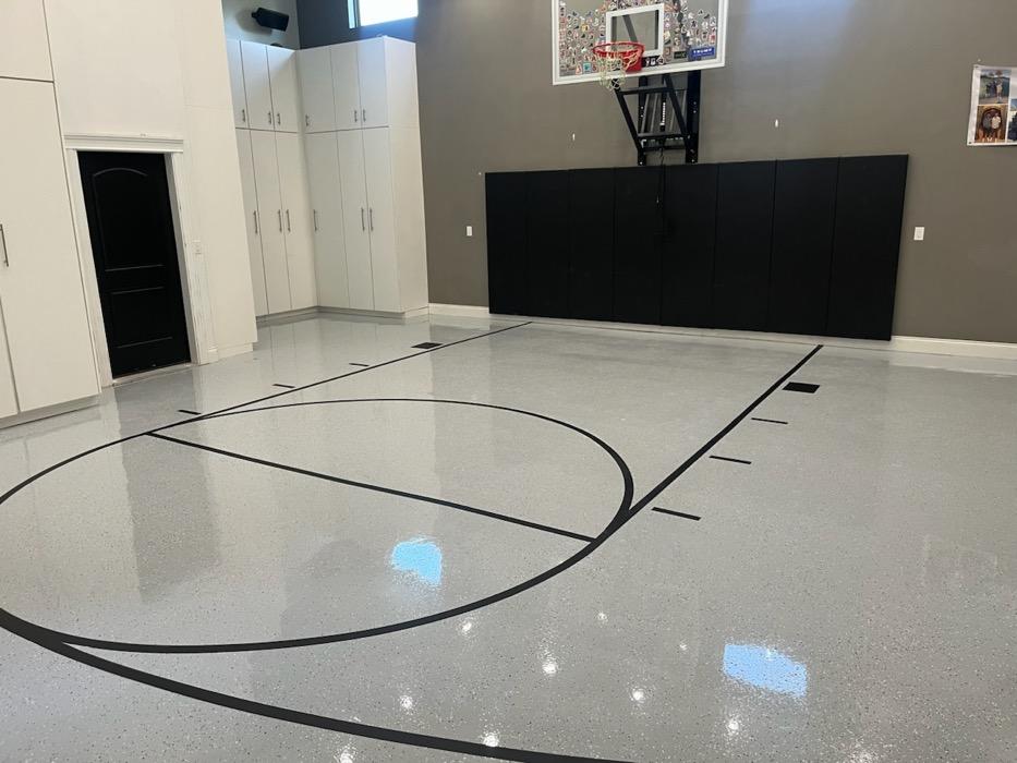 Indoor basketball court in Lehi with a polished finish, black lines and a wall-mounted hoop.
