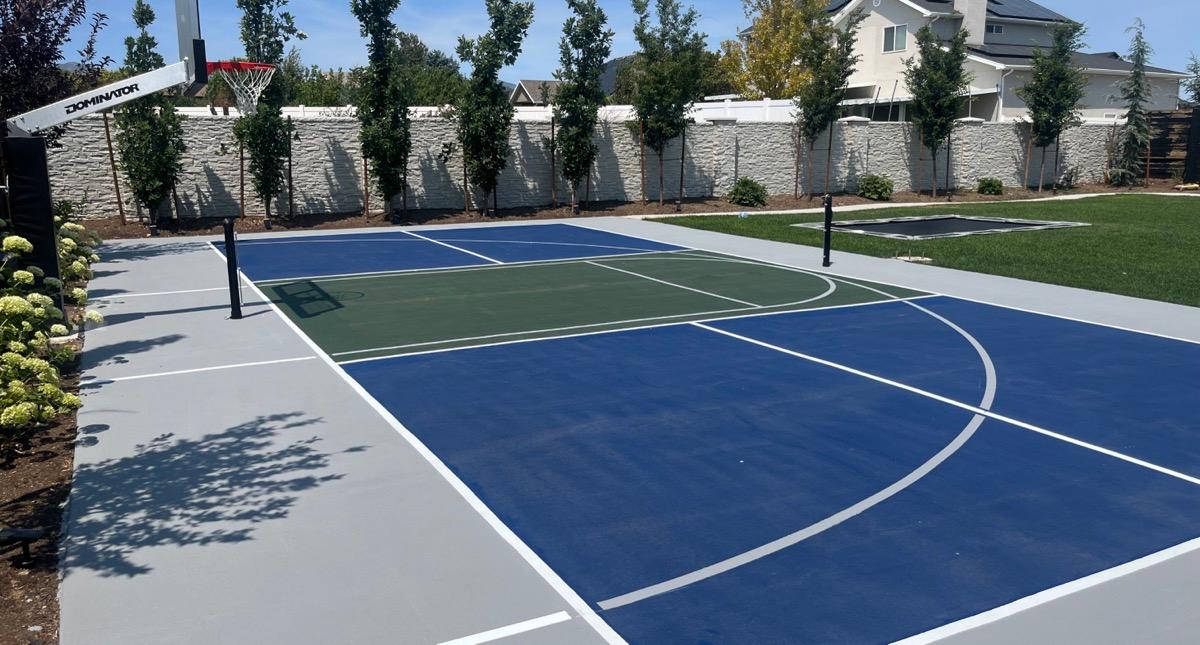 Multi-sport court in Riverton, light grey surround with navy zones and a grass green kitchen.